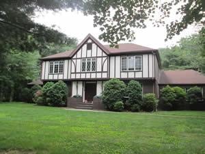 Residential property inspected — Tudor style house with green lawn 1
